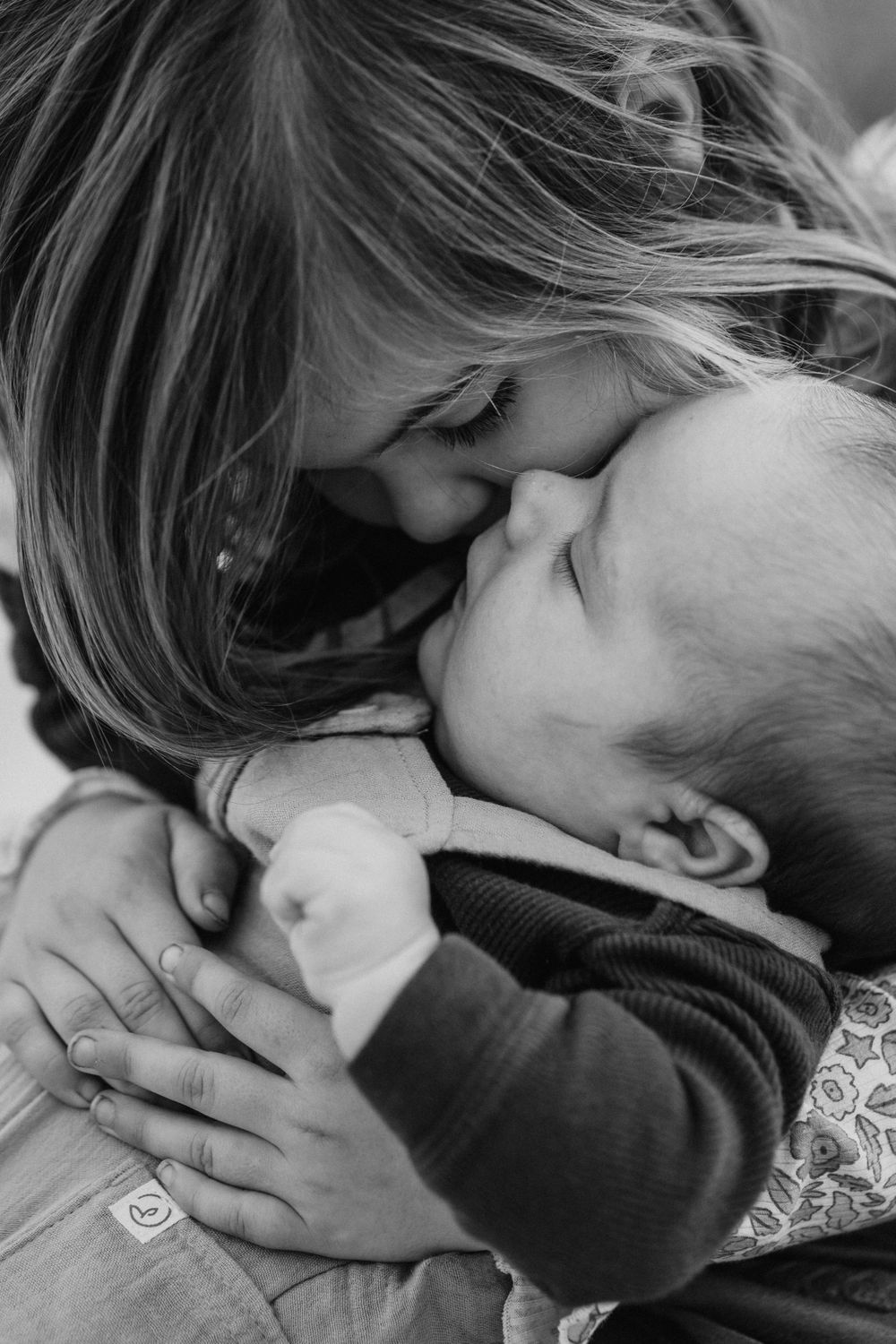 A couple shares an intimate kiss in a romantic black and white portrait sequence.