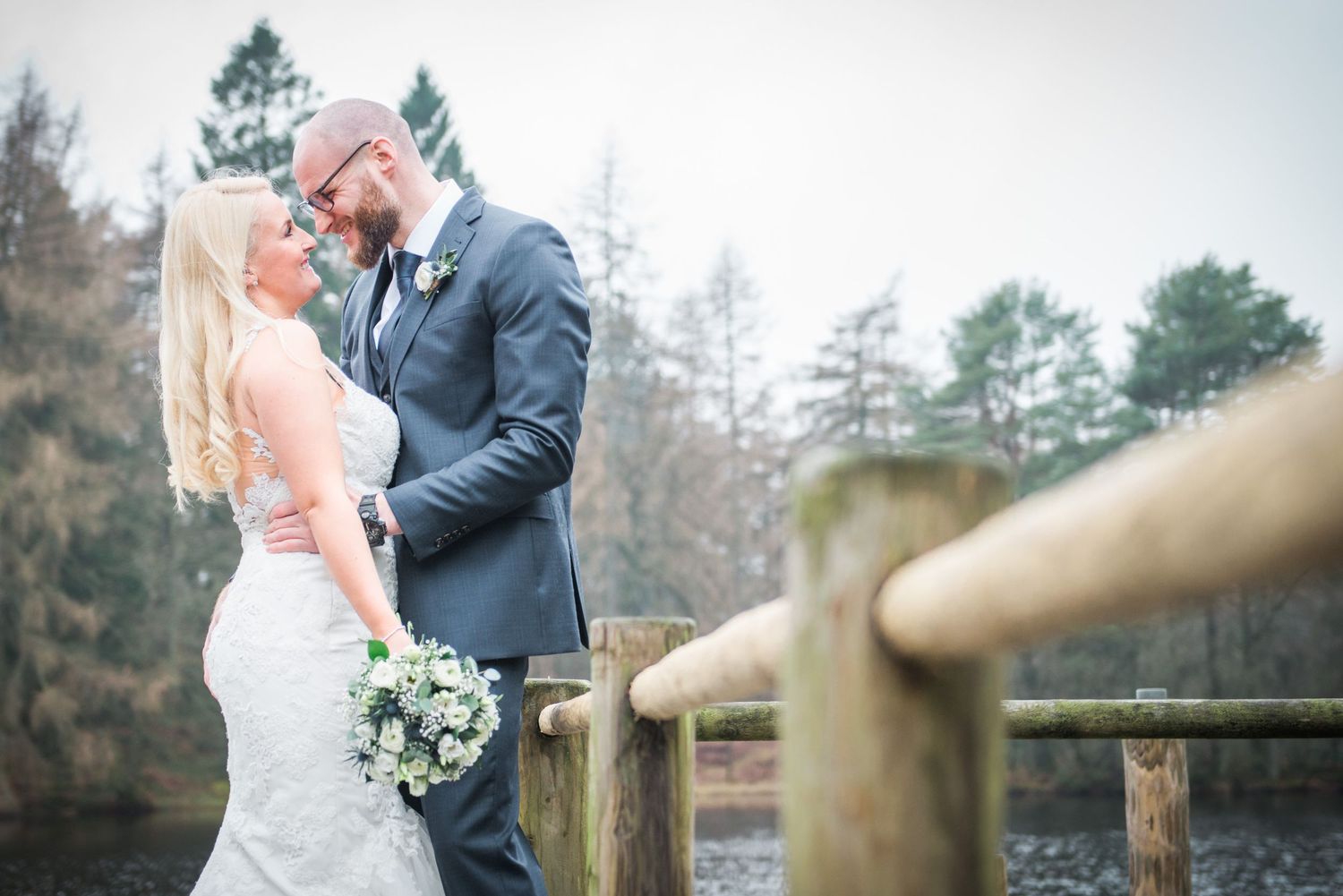 Bride & groom in wedding attire smiling closely after their elopement at Gilpin Lake House