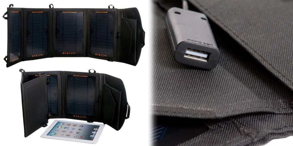 Portable foldable solar panel charger with dual USB ports charging a tablet outdoors.