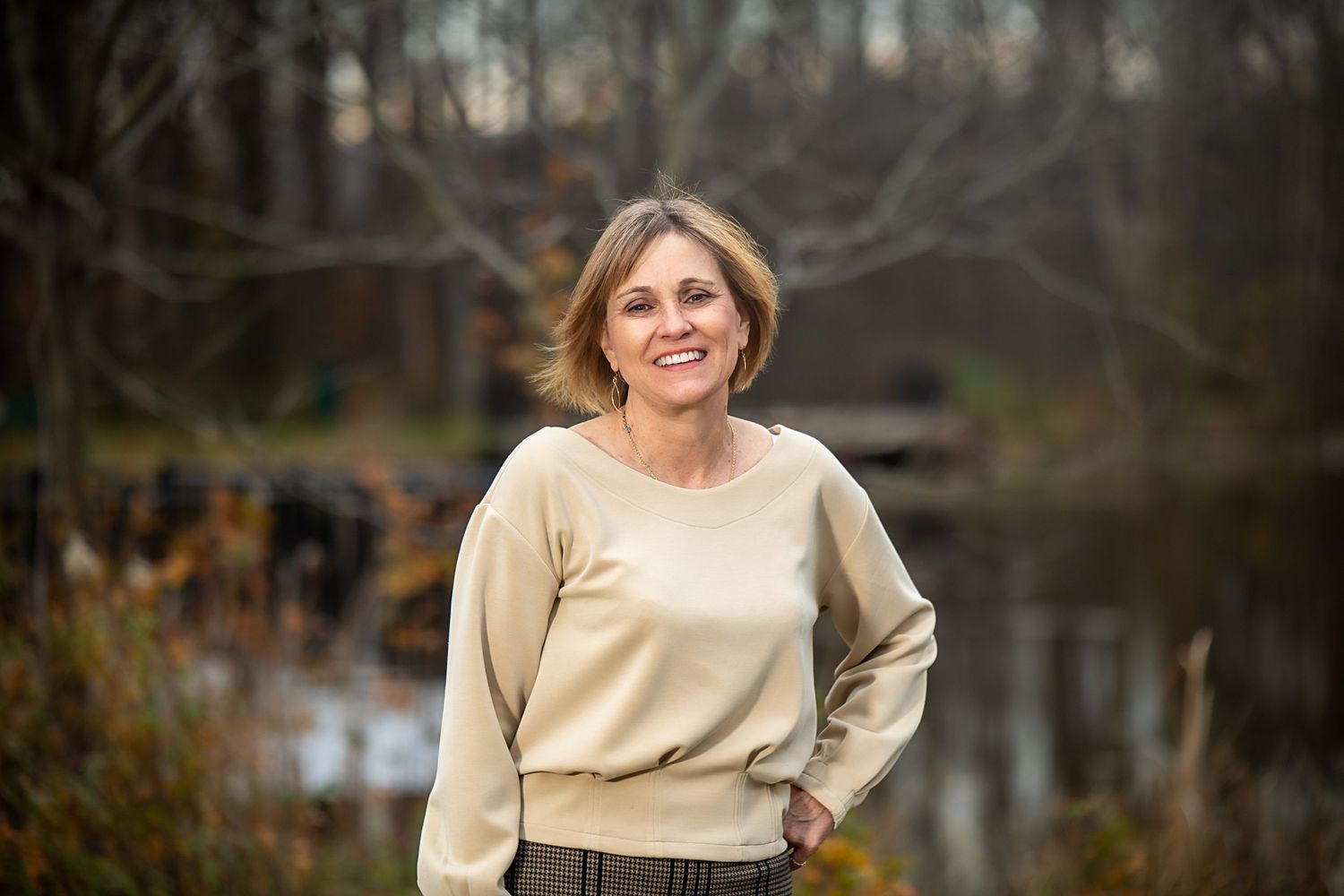 Natural light portraits featuring neutral tones and sweater in outdoor autumn setting.