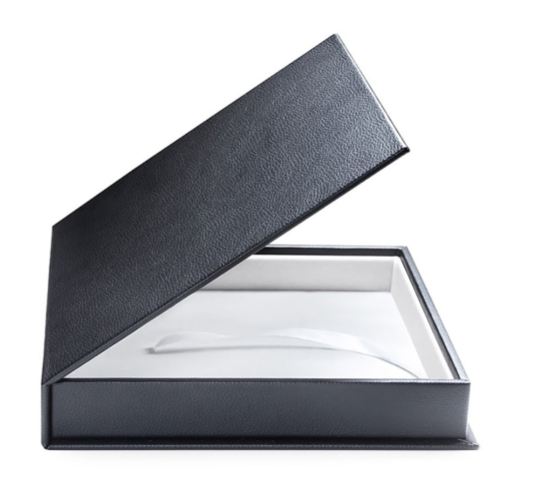 Elegant black leather presentation box with white interior opened at an angle.