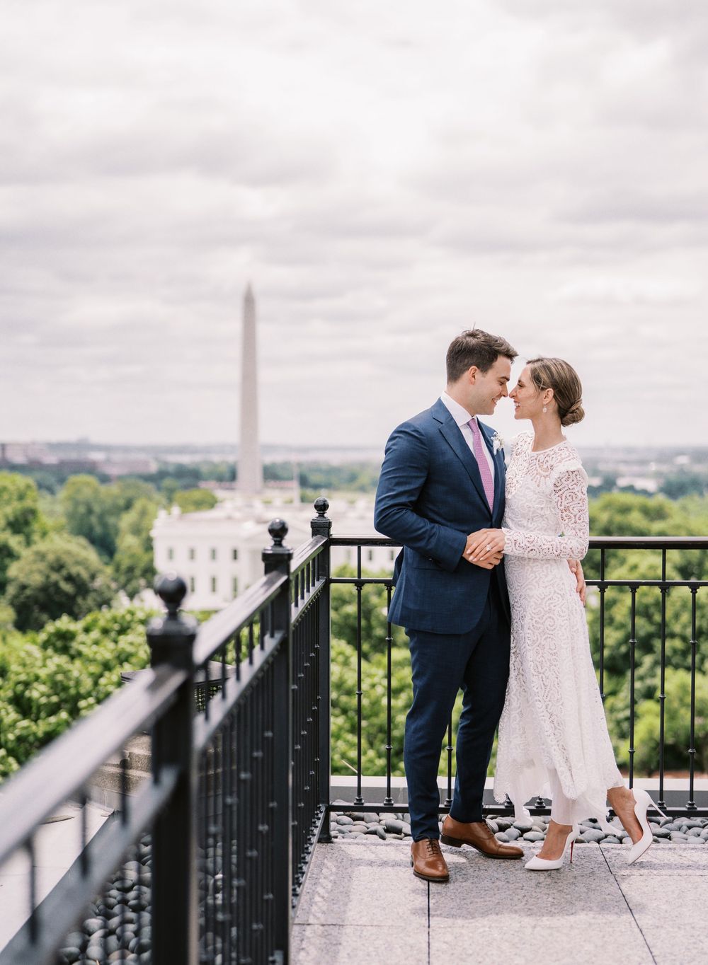 Romantic couple on balcony overlooking Washington Monument and White House.