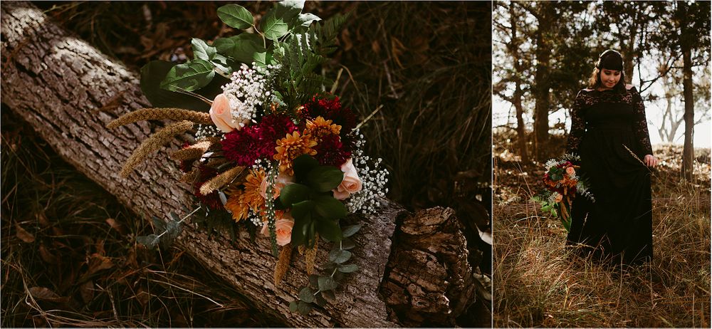 Vibrant autumn floral arrangement rests on rustic fallen tree trunk in moody forest setting.