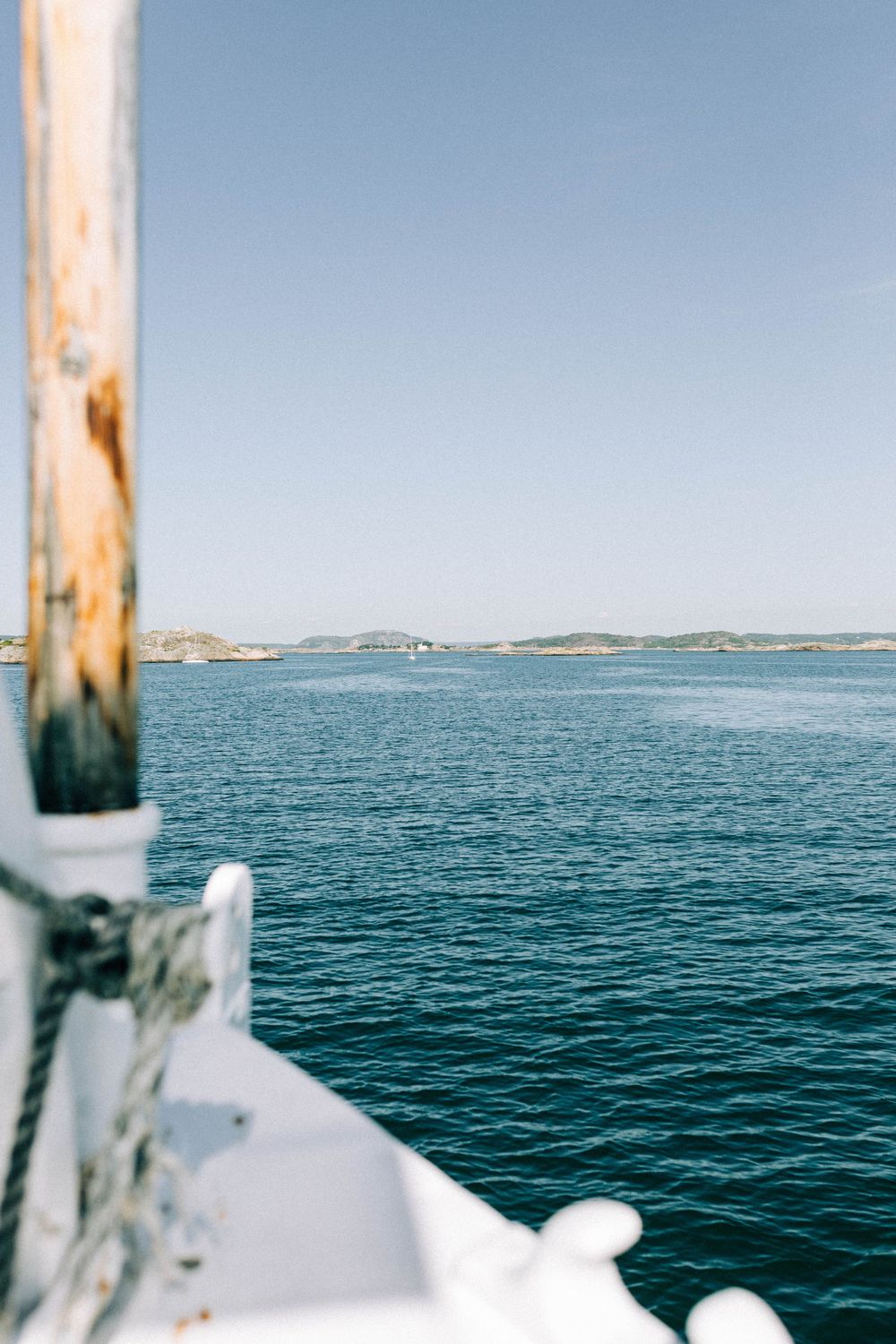 Scenic ocean view from boat showing blue waters and distant coastline on sunny day.