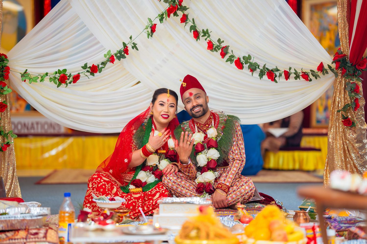 Happy couple showing their rings during traditional Hindu wedding ceremony.
