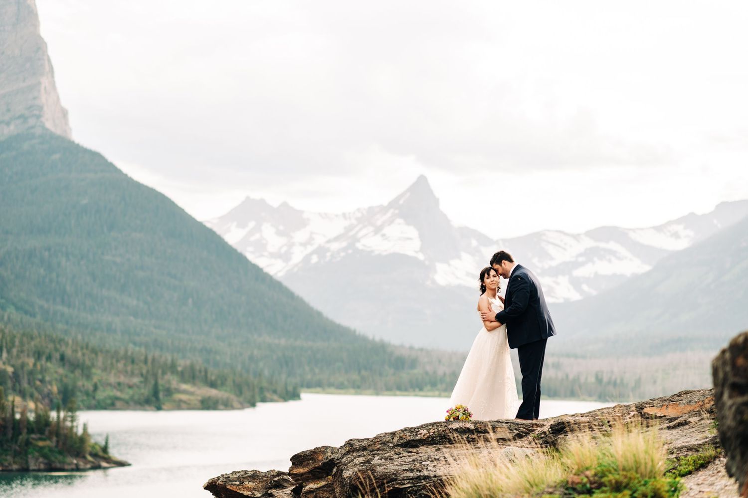 couple getting married at sun point in glacier national park