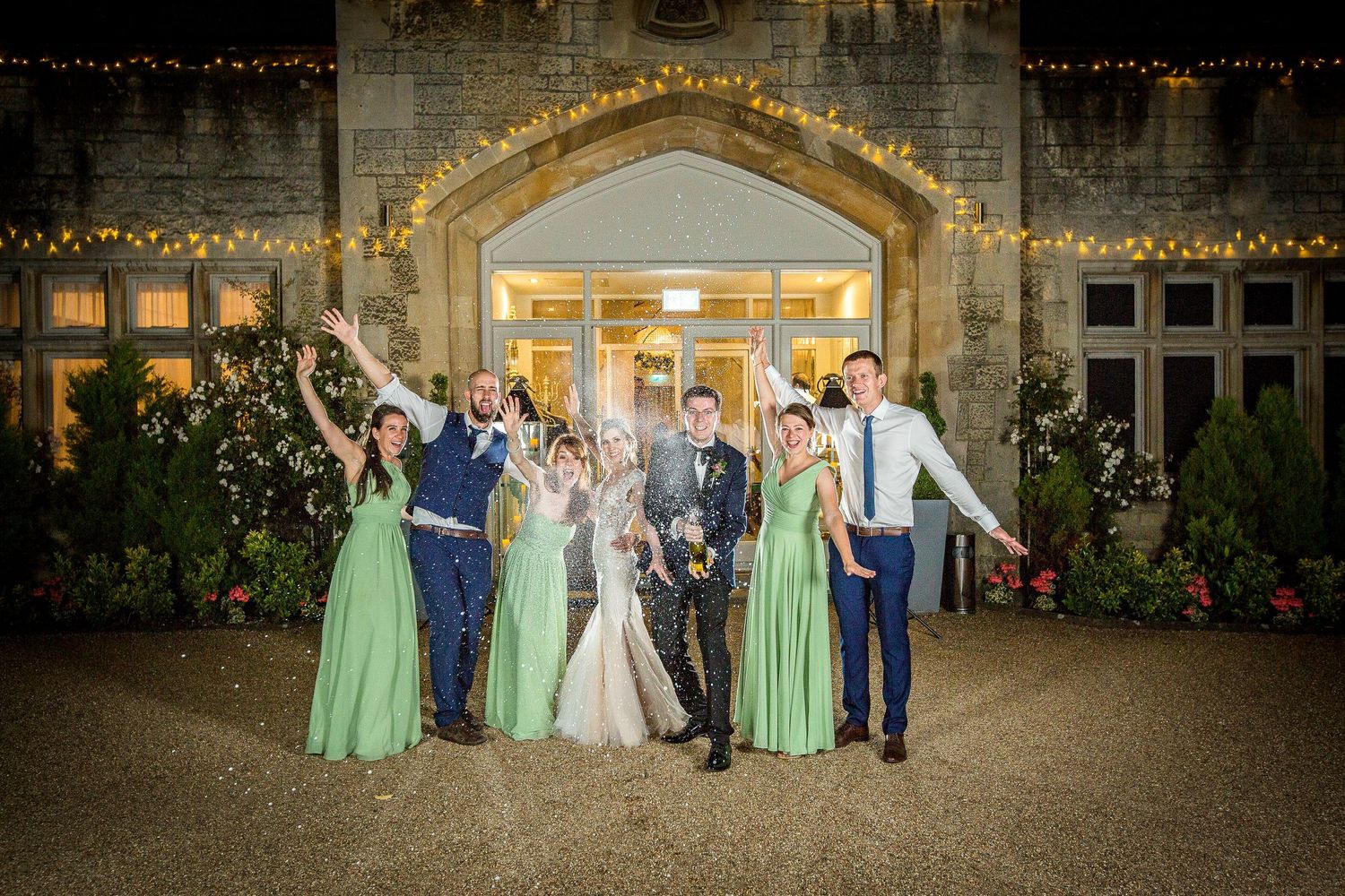 champagne popping wedding photography manor by the lake