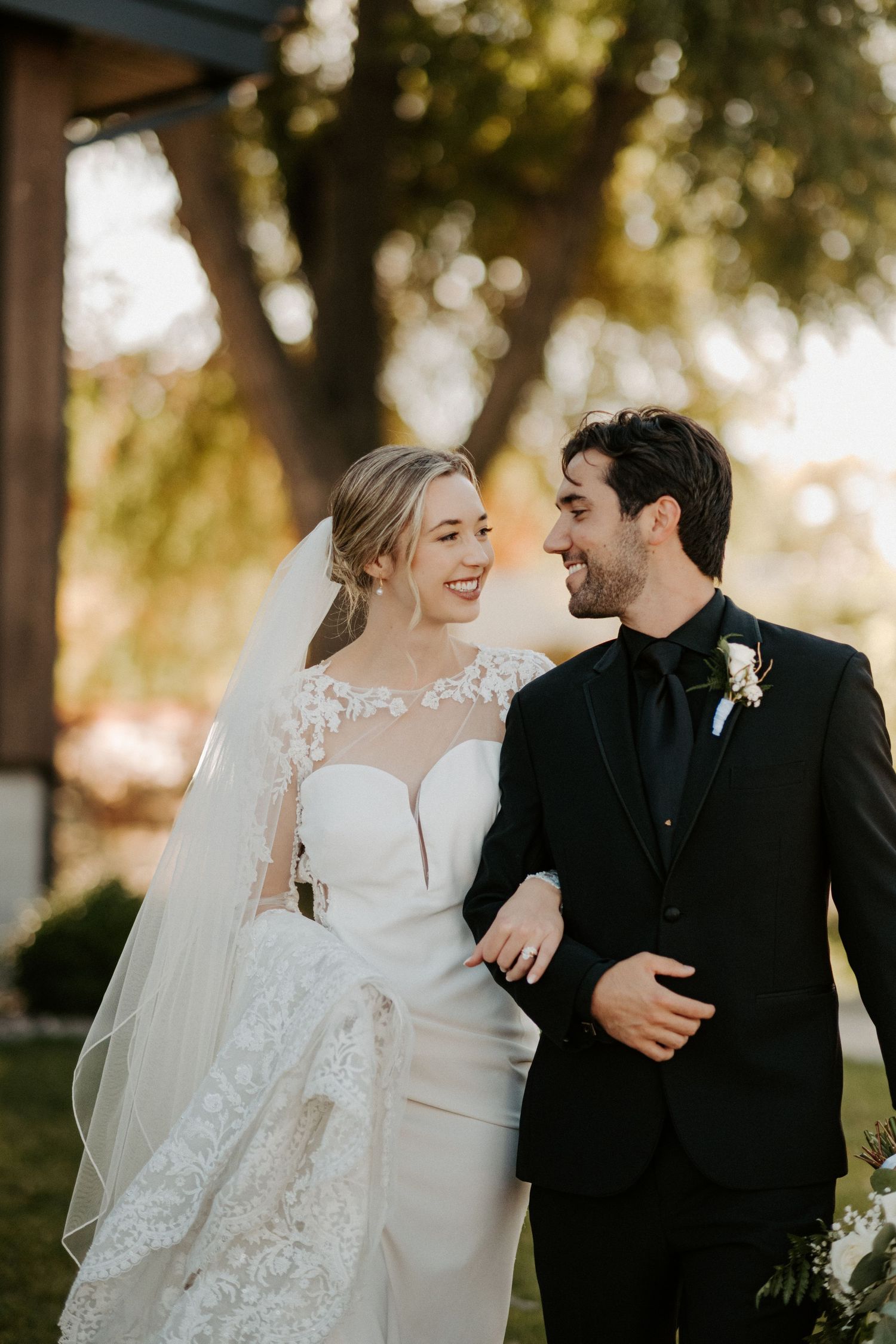 A bride and groom walk arm in arm