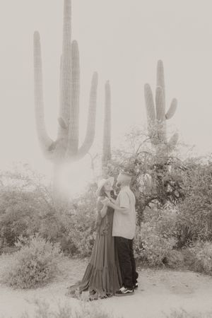 Black and white vintage-style desert portrait with saguaro cactus backdrop.