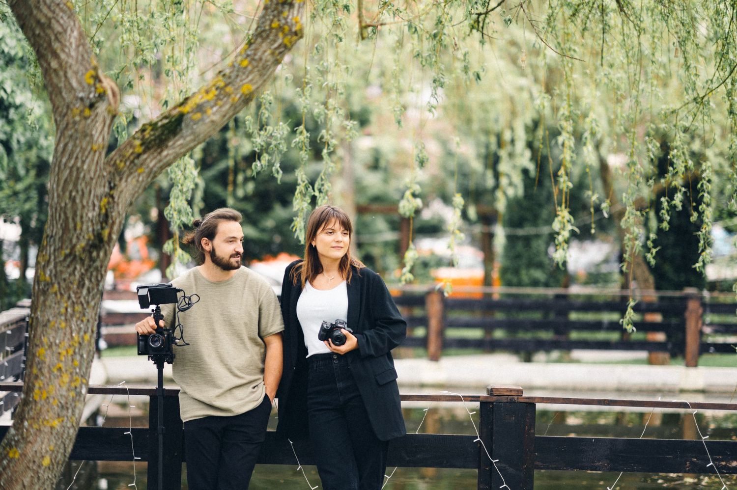 A casual outdoor scene with people walking through a park setting.