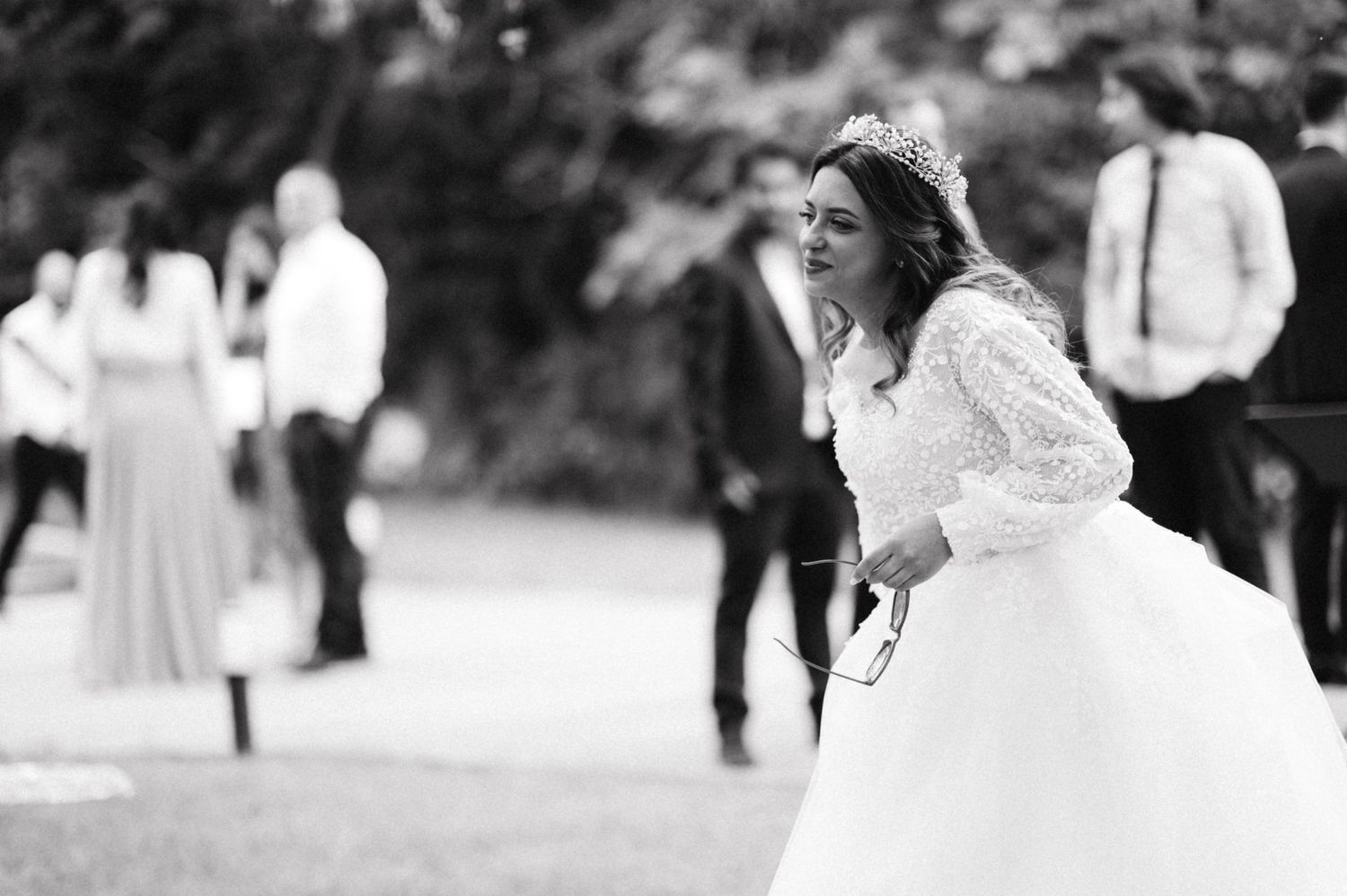 Black and white photograph of a joyful moment at an outdoor celebration.