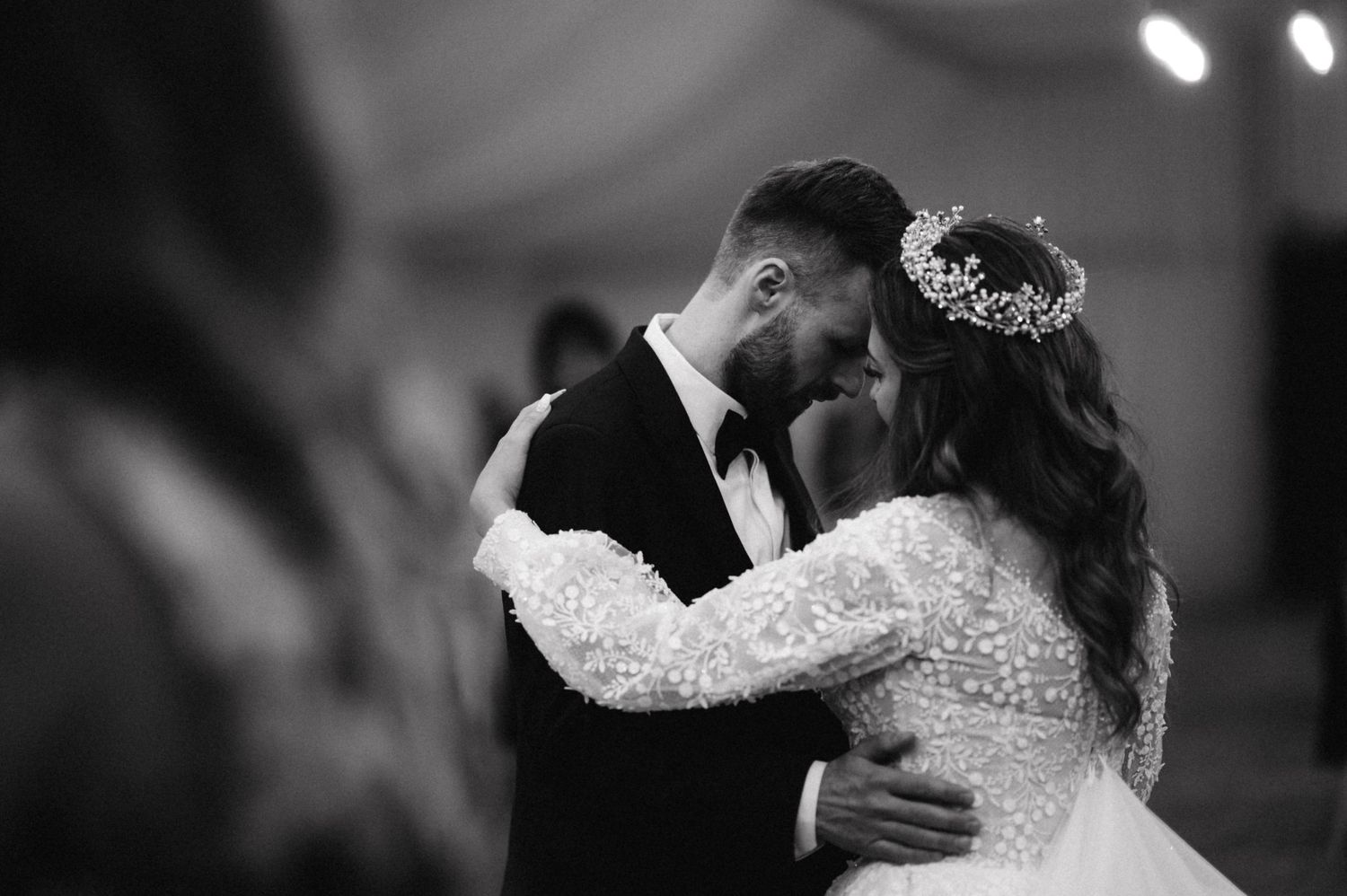 Black and white photo of newlyweds sharing an intimate dance moment.