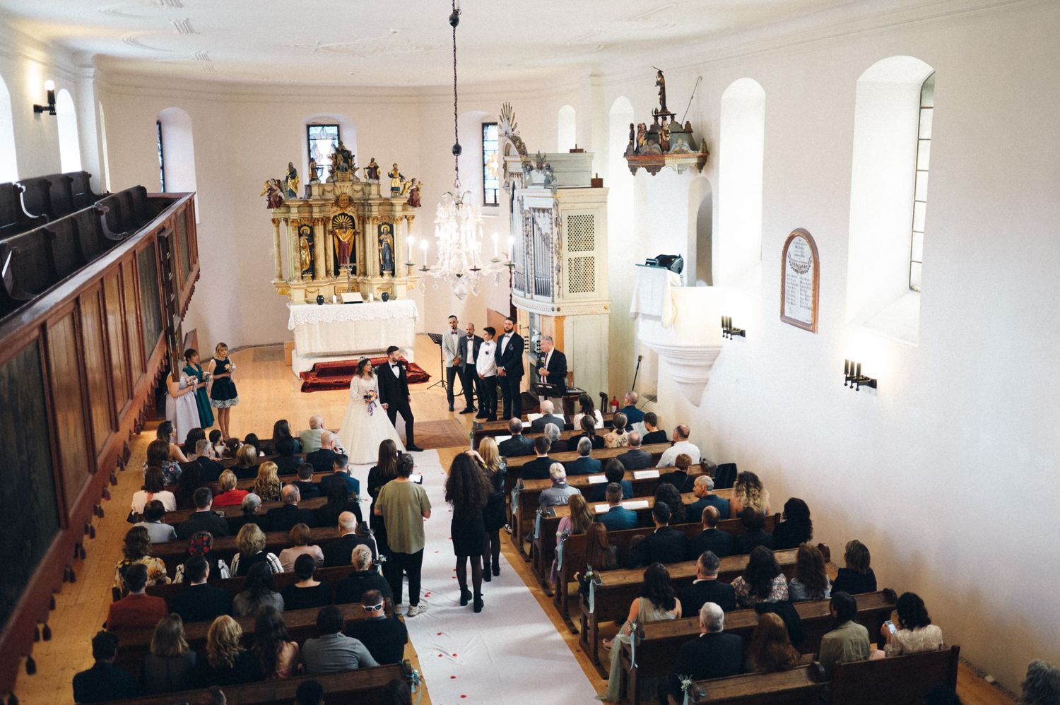 Joyful wedding ceremony moment in bright church interior with classic architecture.