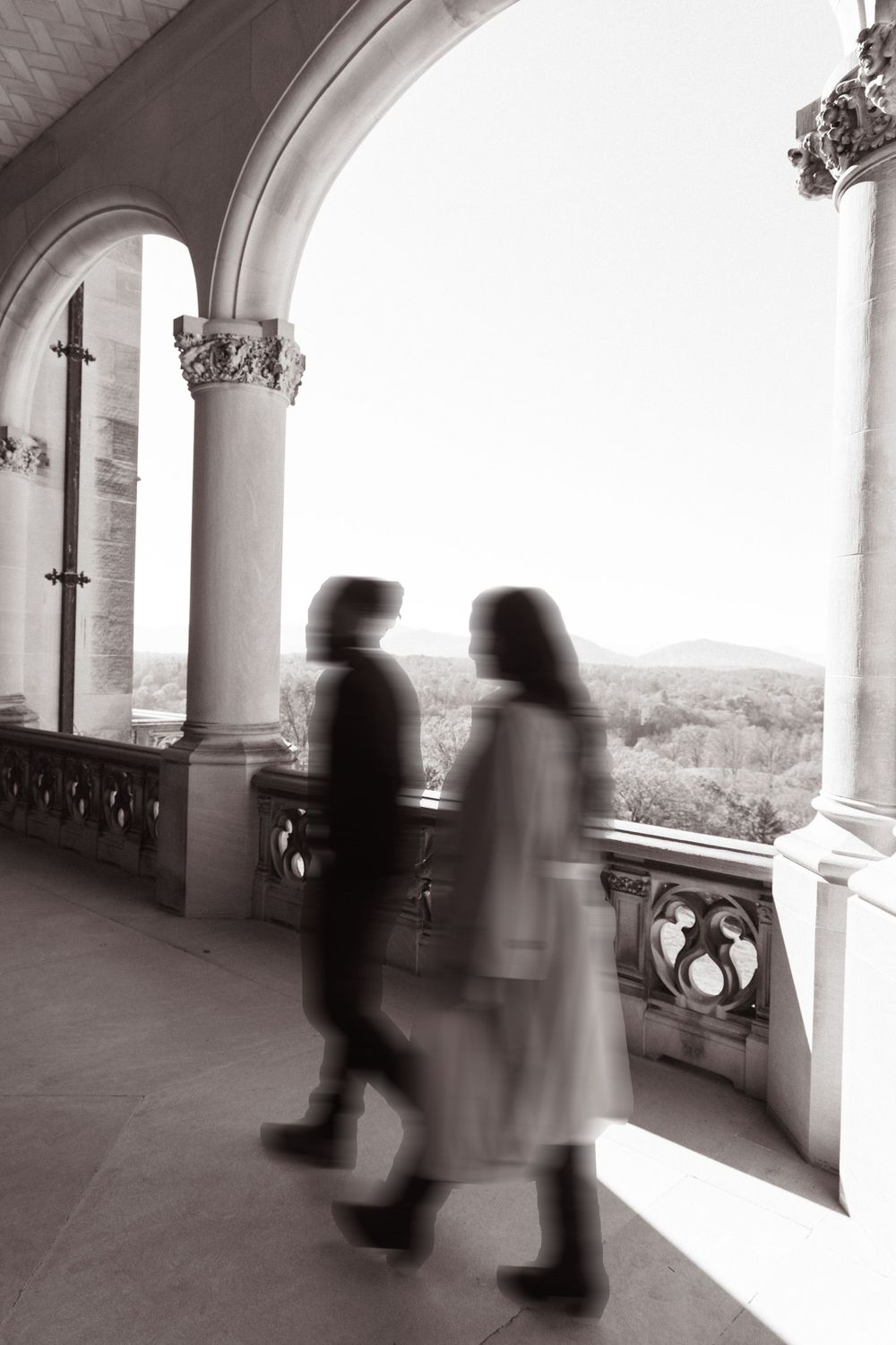 Intimate moment shared between a couple in a castle hallway with soft lighting.
