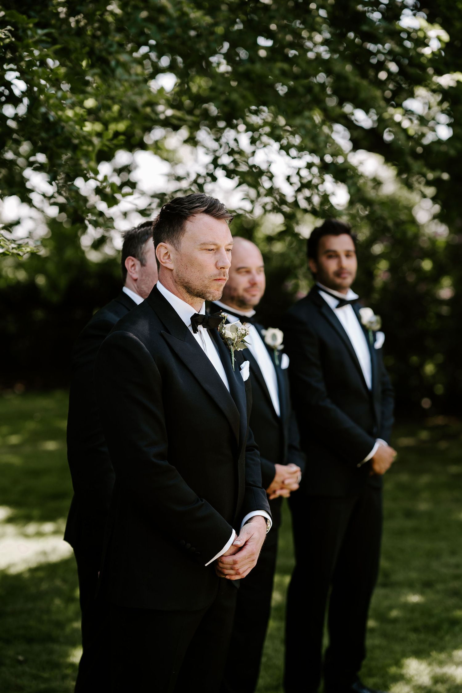 groom-waiting-for-bride-stockton-house-outdoor-wedding-ceremony