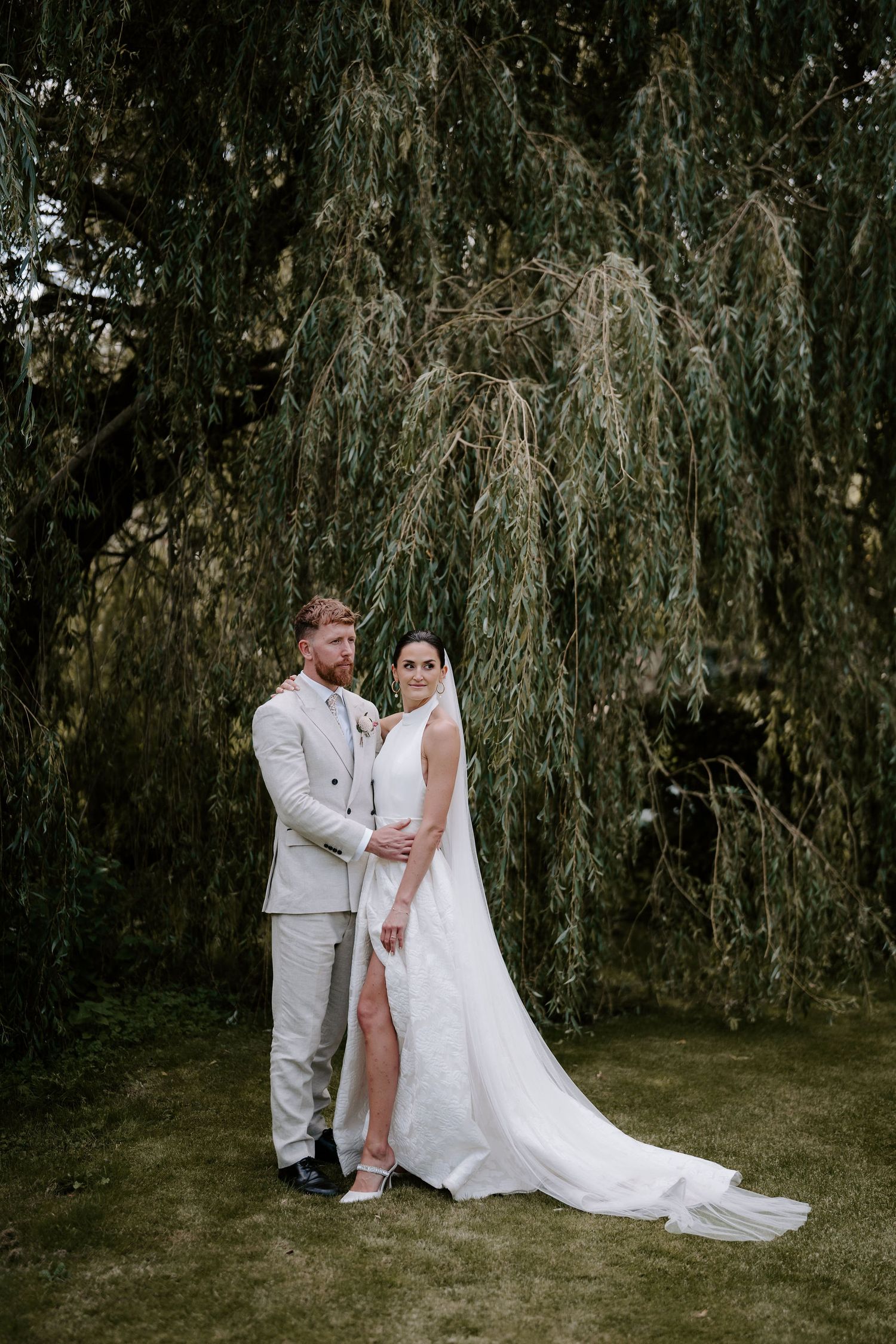 bride and groom stood under willow tree in islip, oxfordshire