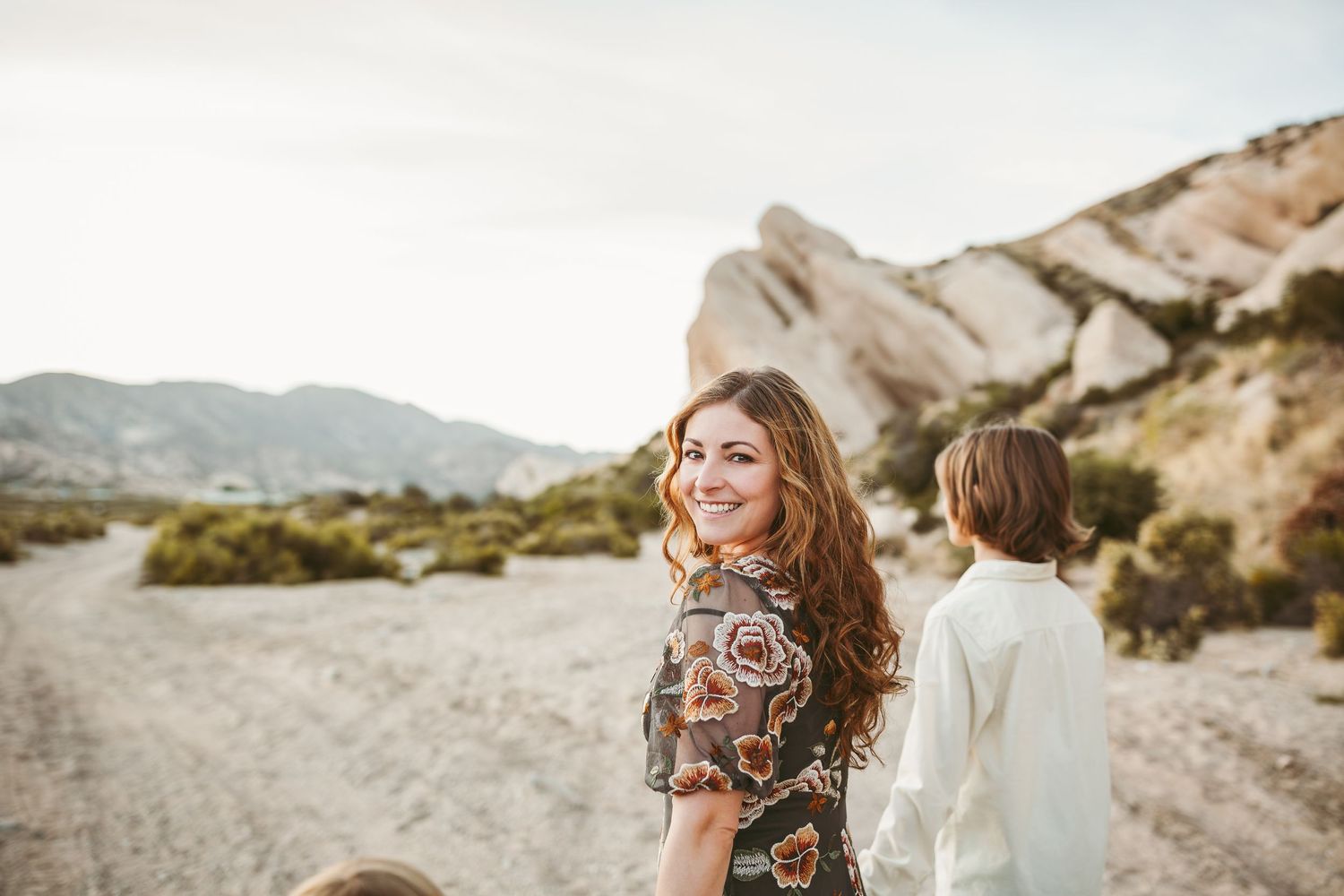 a beautiful mothers is looking into the camera smiling in beaumont ca
