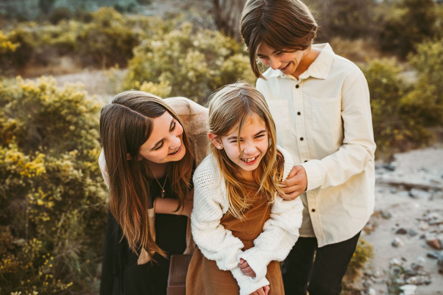 three siblings laughing in the phelan desert in the inland empire with heidi grace photography