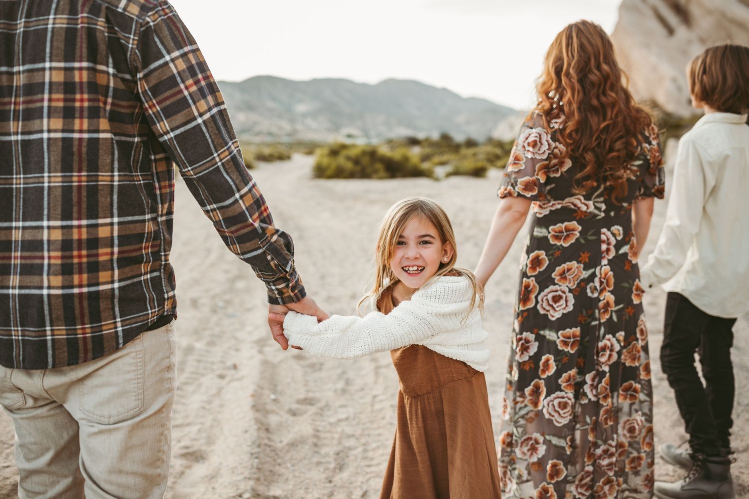 a small child turns around and laughs during a photo session in yucaipa ca