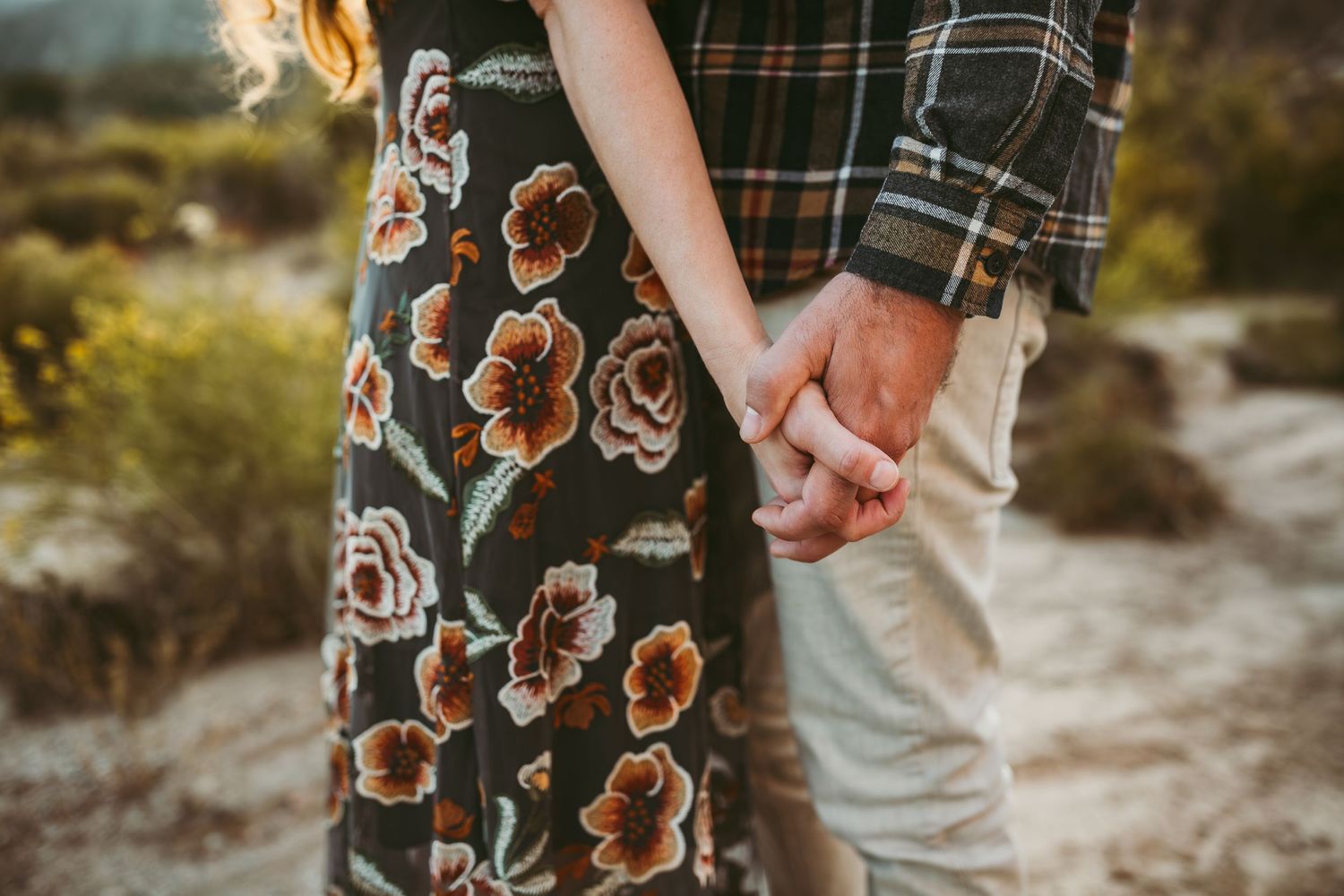 a close up photo of a couple holding hands in redlands ca