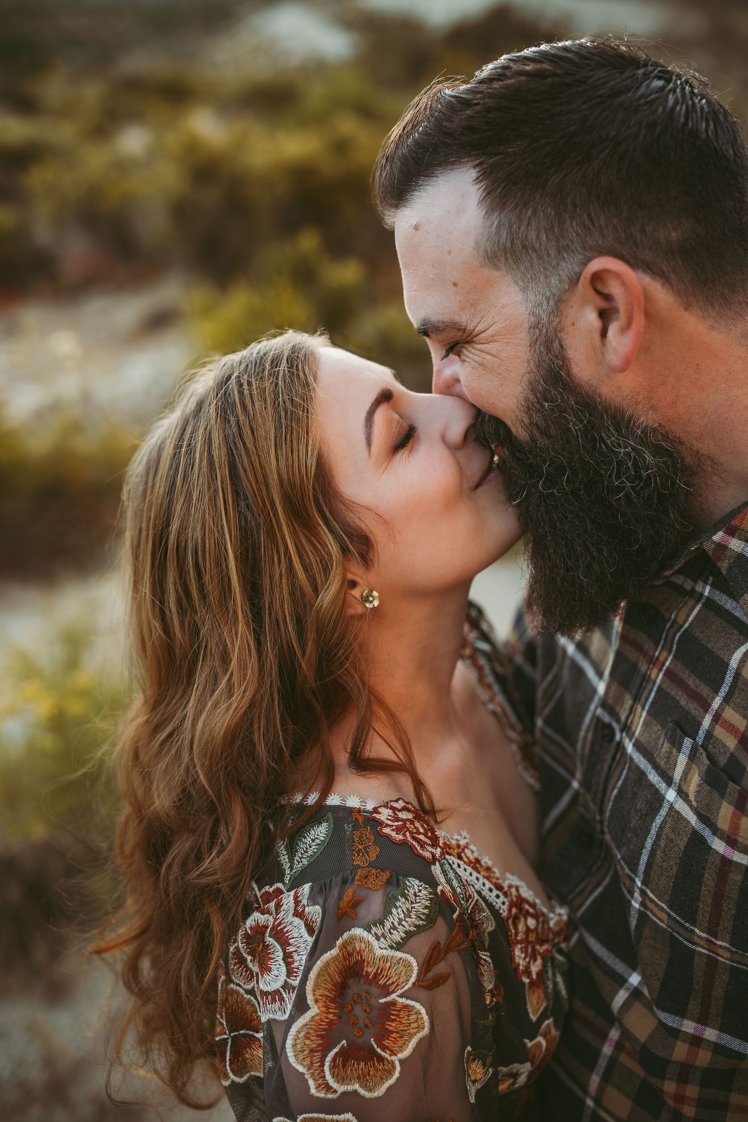 husband and wife sharing a kiss during their couples session in the inland empire ca