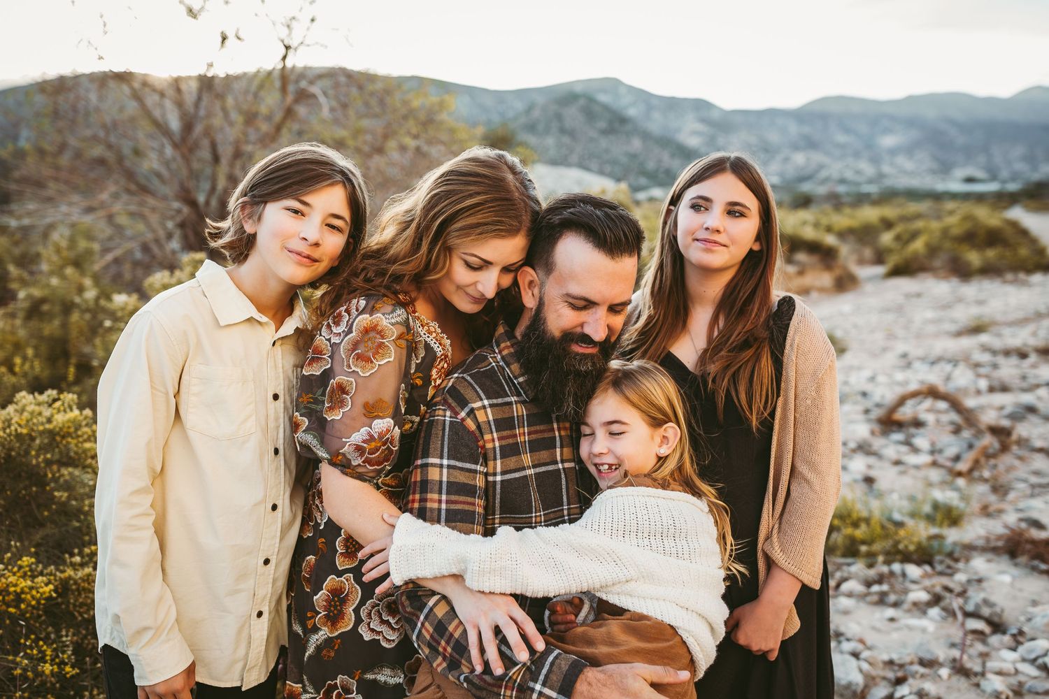 a family of five cuddling for photos in yucaipa ca with heidi grace photography