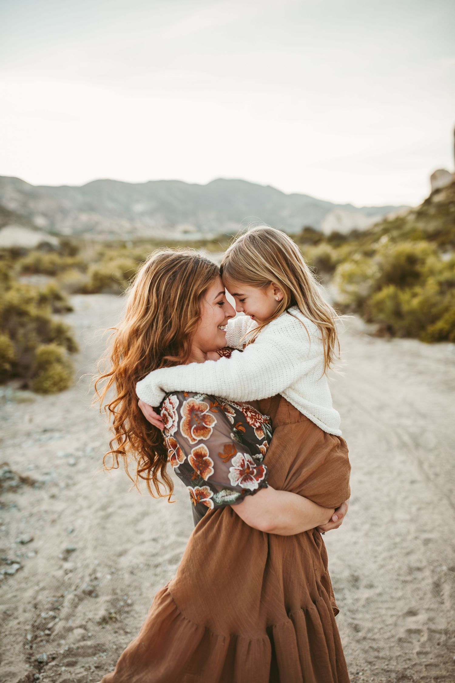 a mother holds her young child and they touch their heads together in yucaipa ca