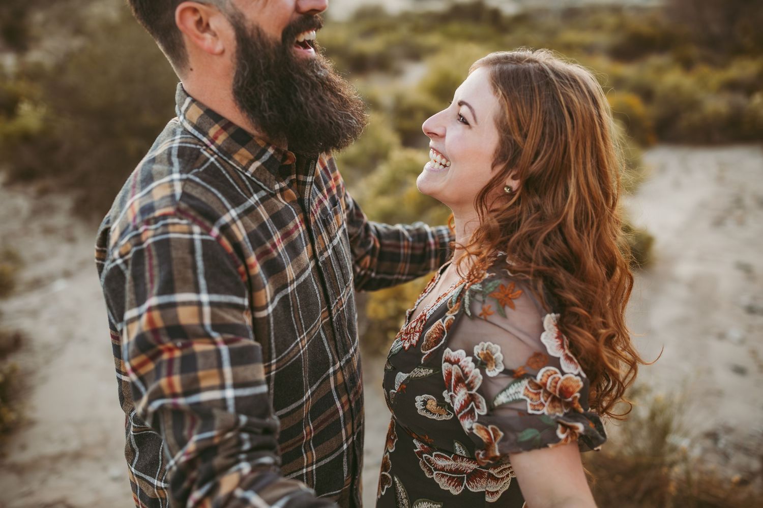 a women lovingly looks up at her husband while holding hands in the inland empire ca