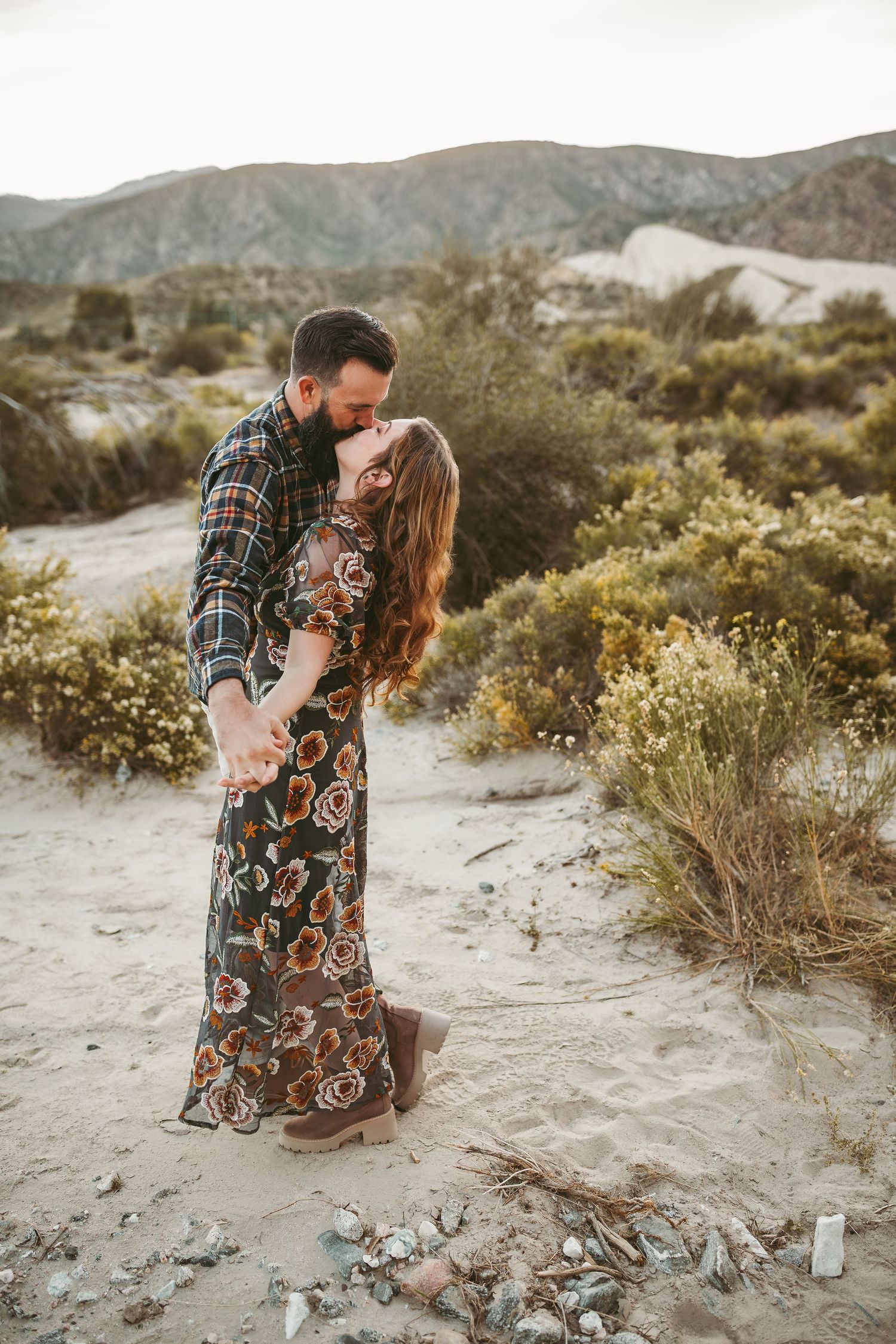 a man and wife dance in the desert with heidi grace photography takes their photo