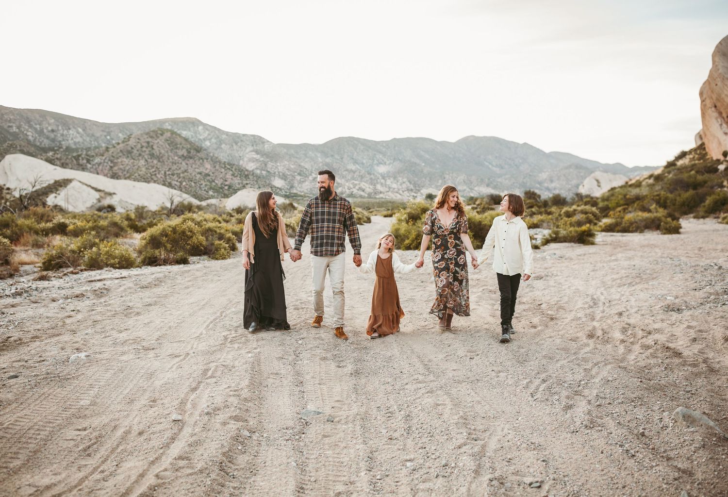 a family of five walking through the desert in phelan ca with heidi grace photography