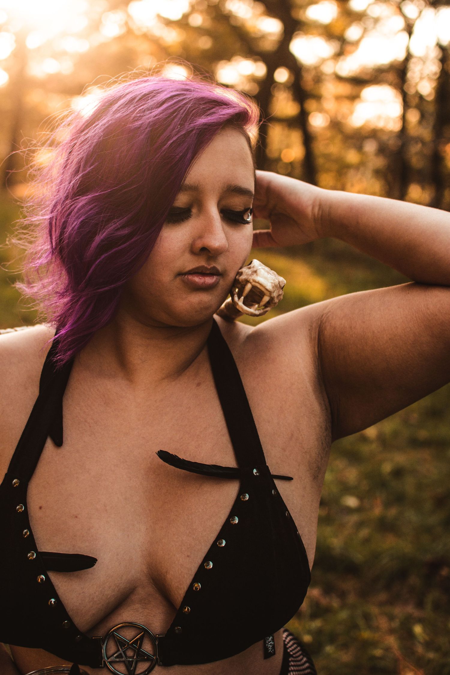 Alternative style portrait with purple hair in dramatic sunset lighting.