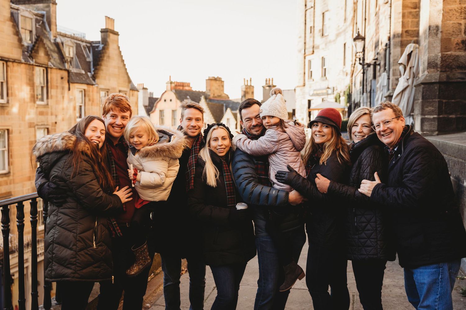 Group photo of people gathered together on a historic stone street.