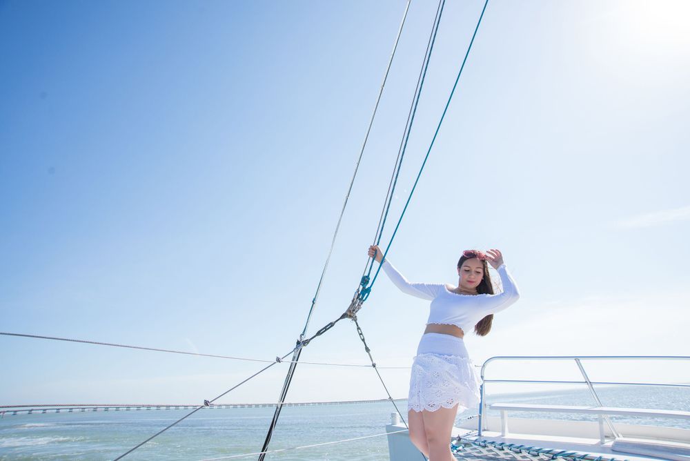 girl posing in a boat enjoying the sun. South Padre Island. Quinceanera. Wedding photography