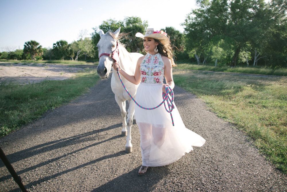 girl walking along with horse. white dress. country ranch. wedding photographer