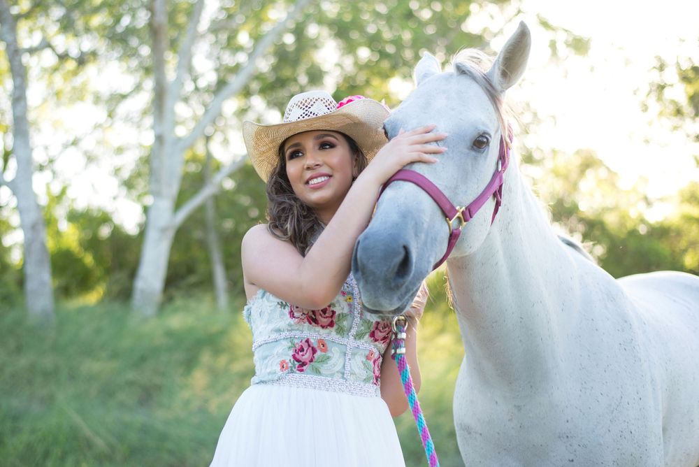 girl holding a horse smiling. country ranch. mcallen, texas. wedding photography