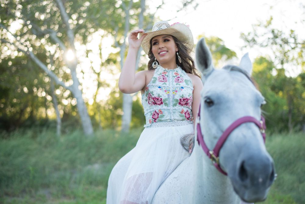 girl riding a horse holding her cowboy hat. country ranch. mcallen, texas. wedding photography