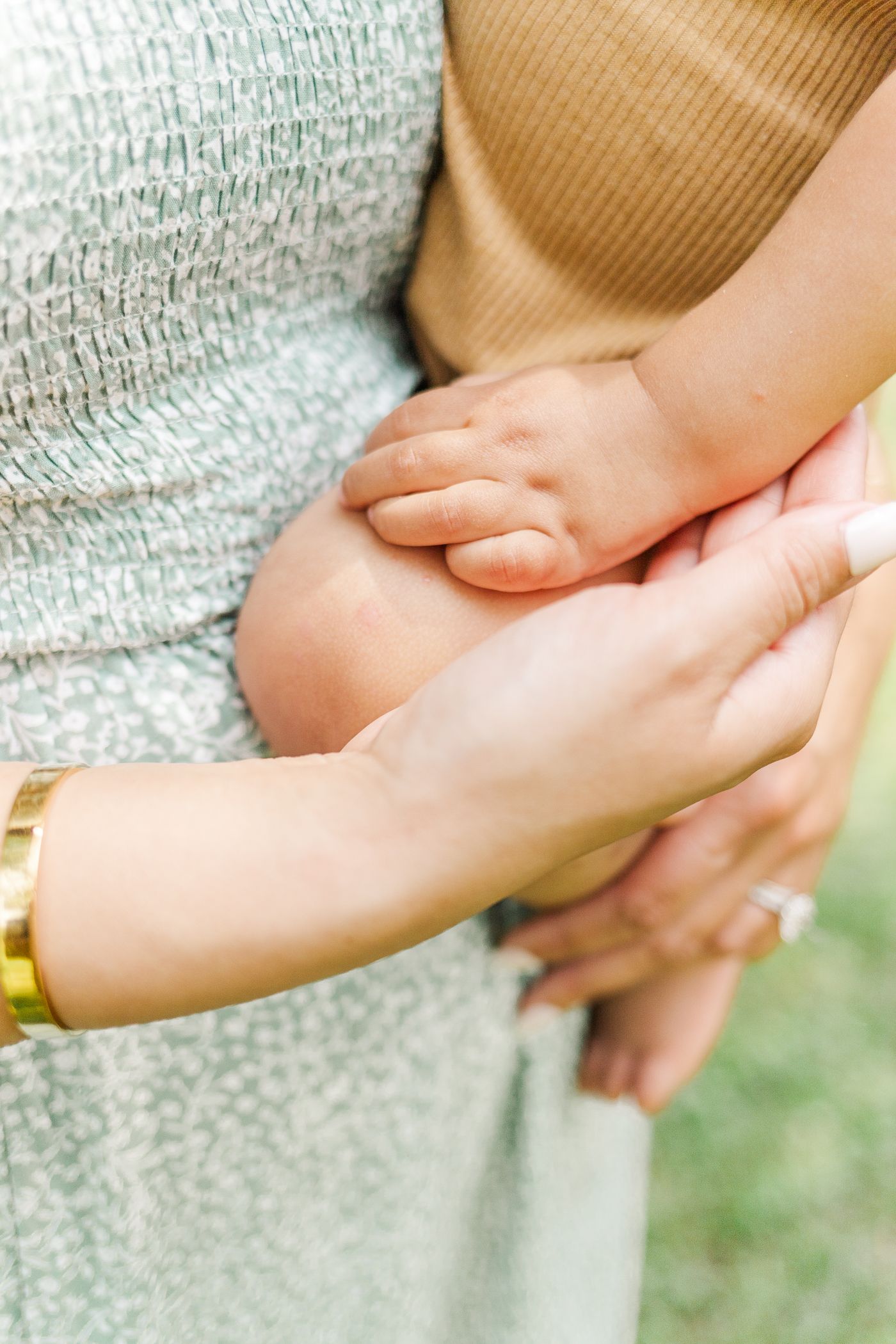 Close up of a mother touching her baby's hand during a Hudson Valley spring family session