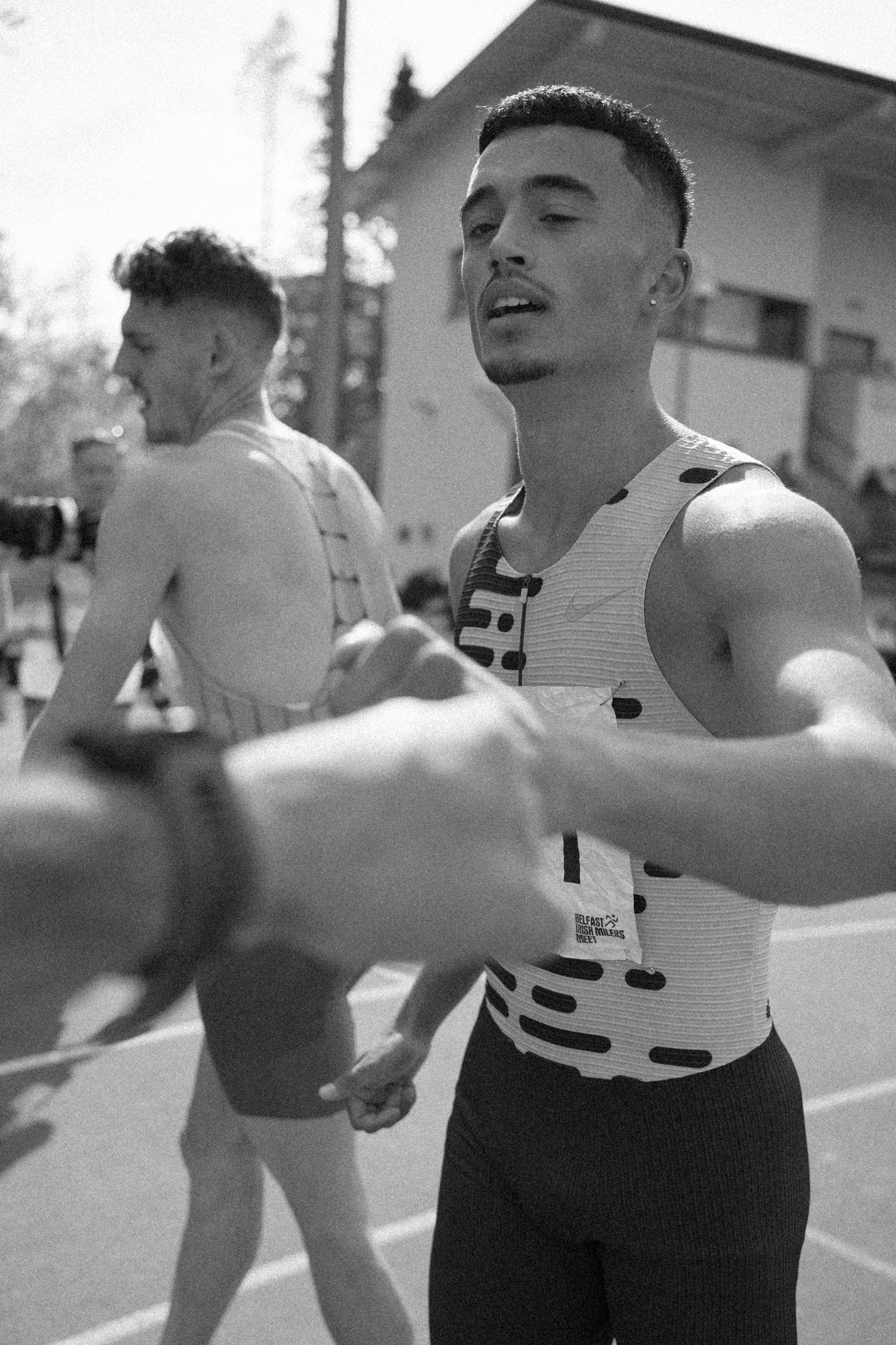 Athletes in sportswear competing at an outdoor track event.