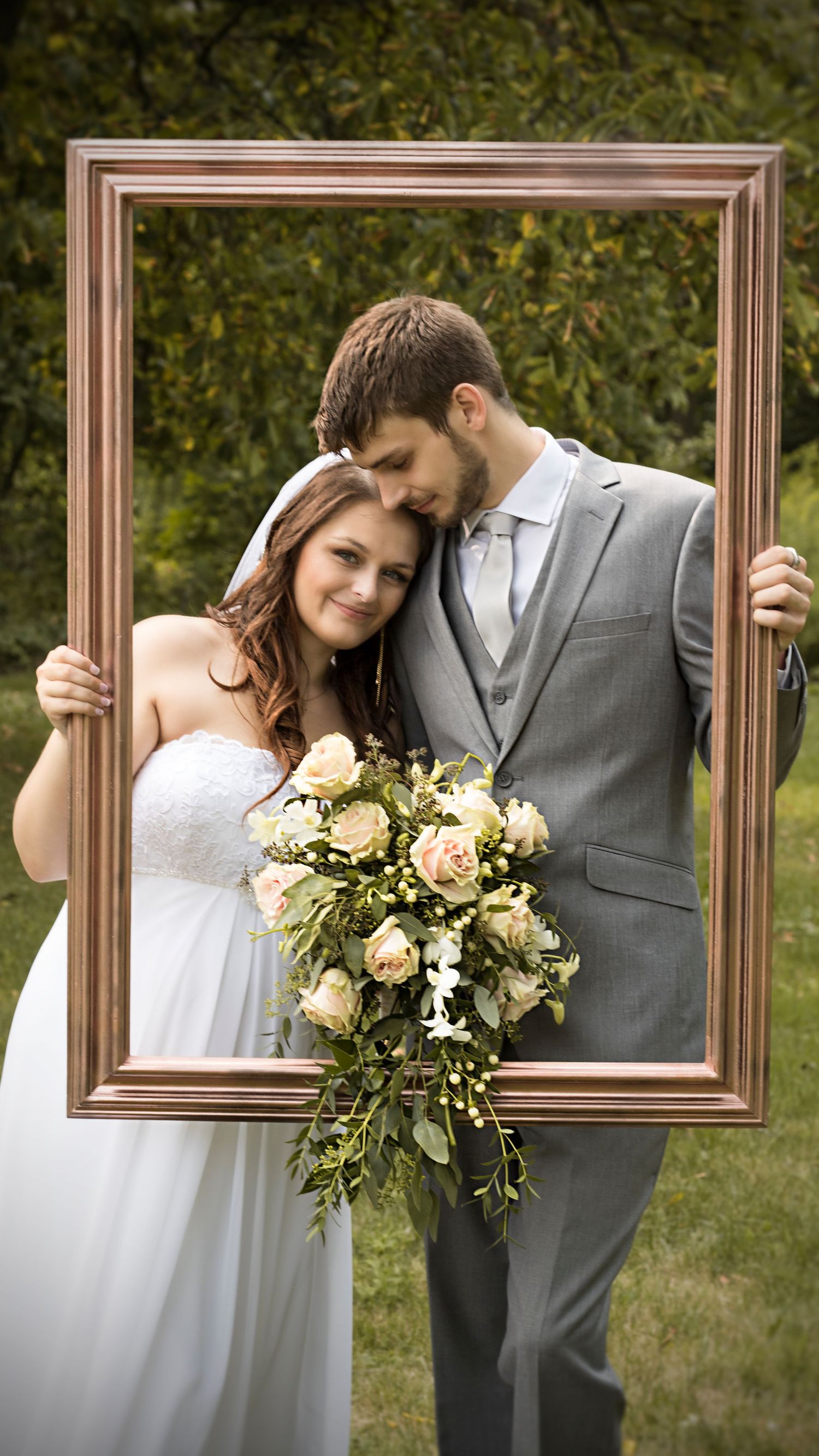 Wedding photos with a vintage frame prop showing romantic poses and floral bouquet.
