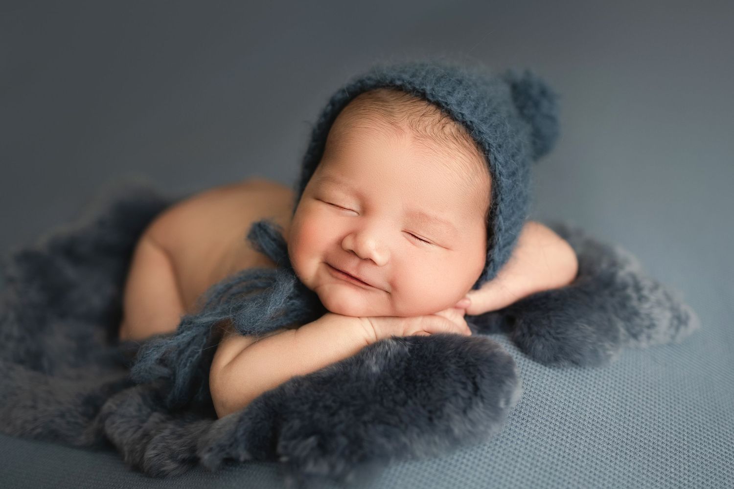 baby smiling in newborn photo