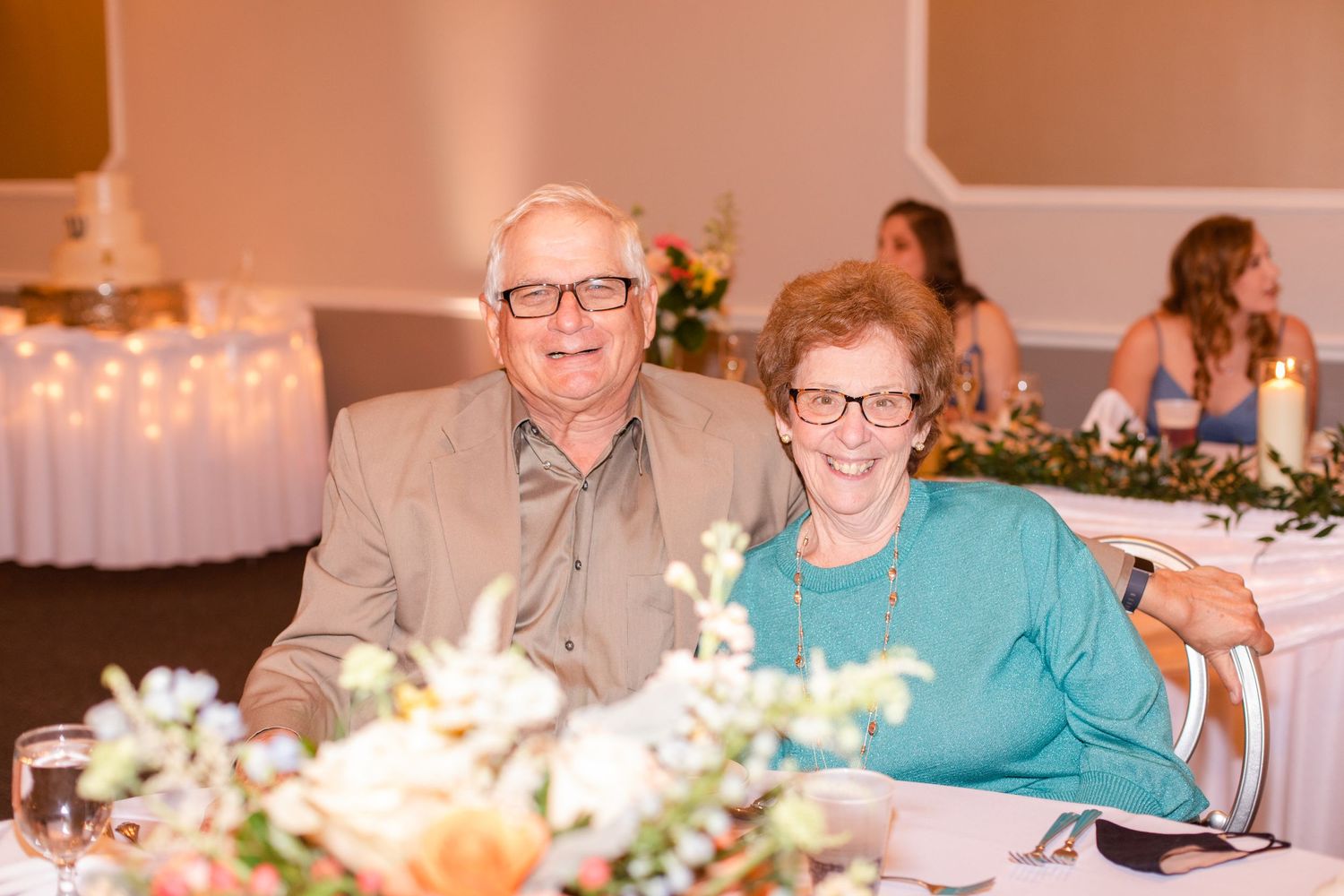 Wedding reception dinner tables with guests seated in an elegant banquet hall.