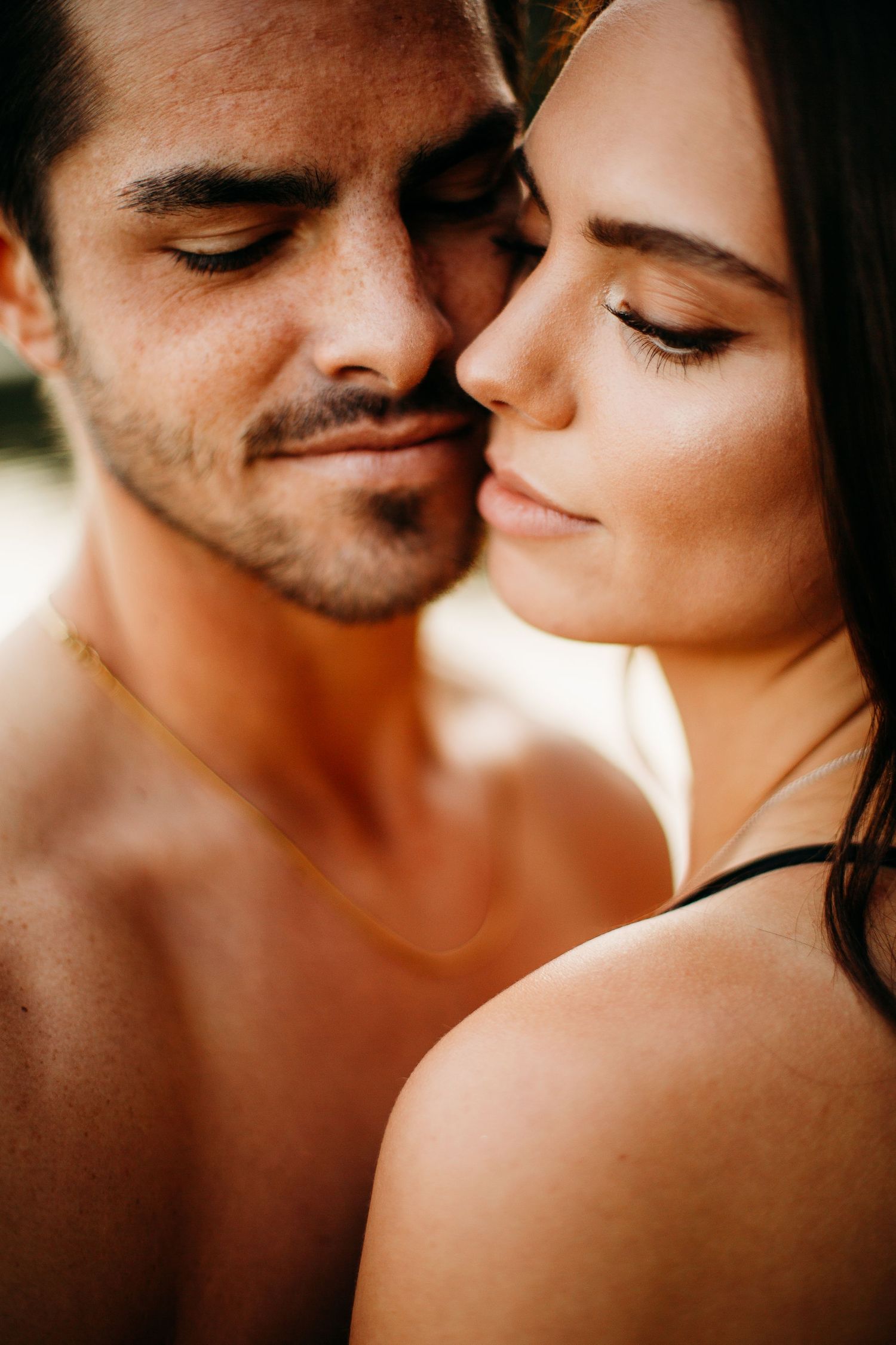 Close up of a couples faces slightly smiling