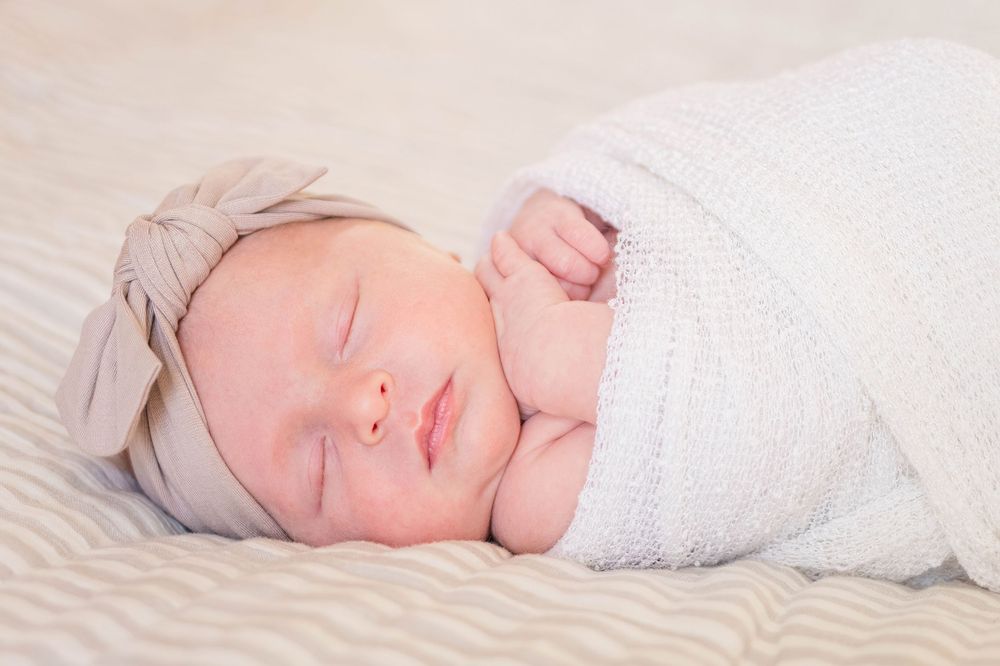 A newborn baby swaddled during a lifestyle newborn session in Cincinnati