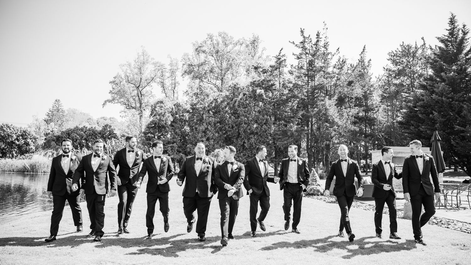 he groom walks surrounded by his groomsmen.