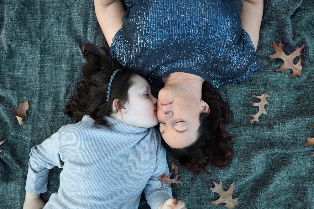 Mother Daughter on a blanket with Autumn leaves.