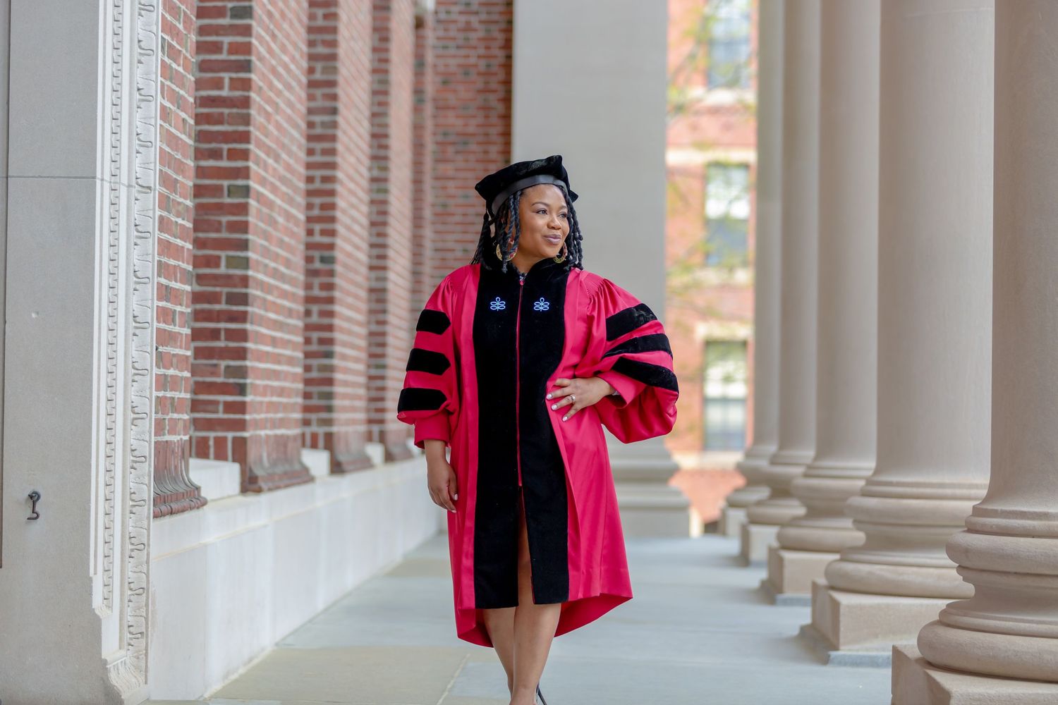 Young professional posing for  graduation pictures at Harvard Boston