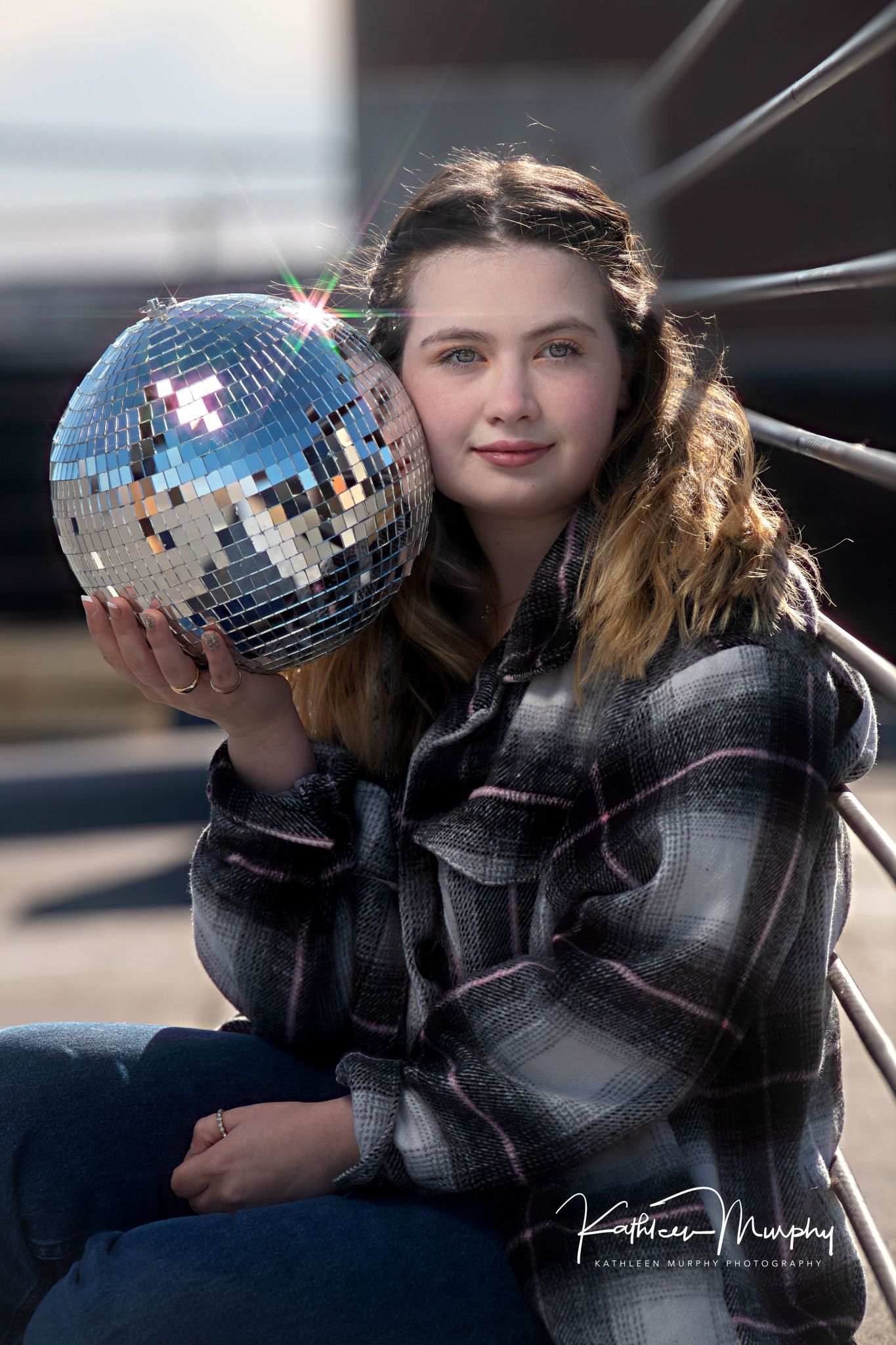 Portrait with silver disco ball and plaid flannel jacket.