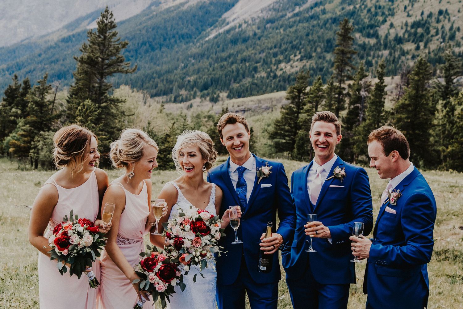 Bridal party toast and laugh in Banff mountains