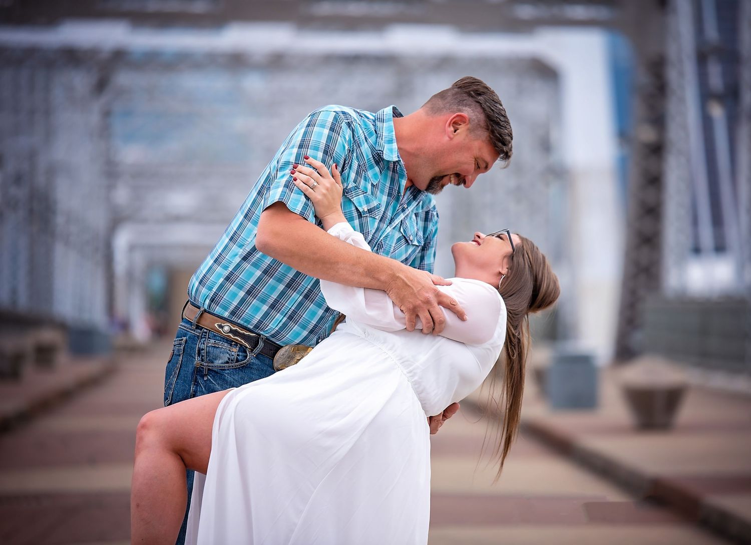 A romantic dance dip pose captured in an urban setting.