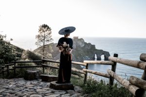 Scenic coastal views from a mountain trail with wooden railings overlooking the ocean.
